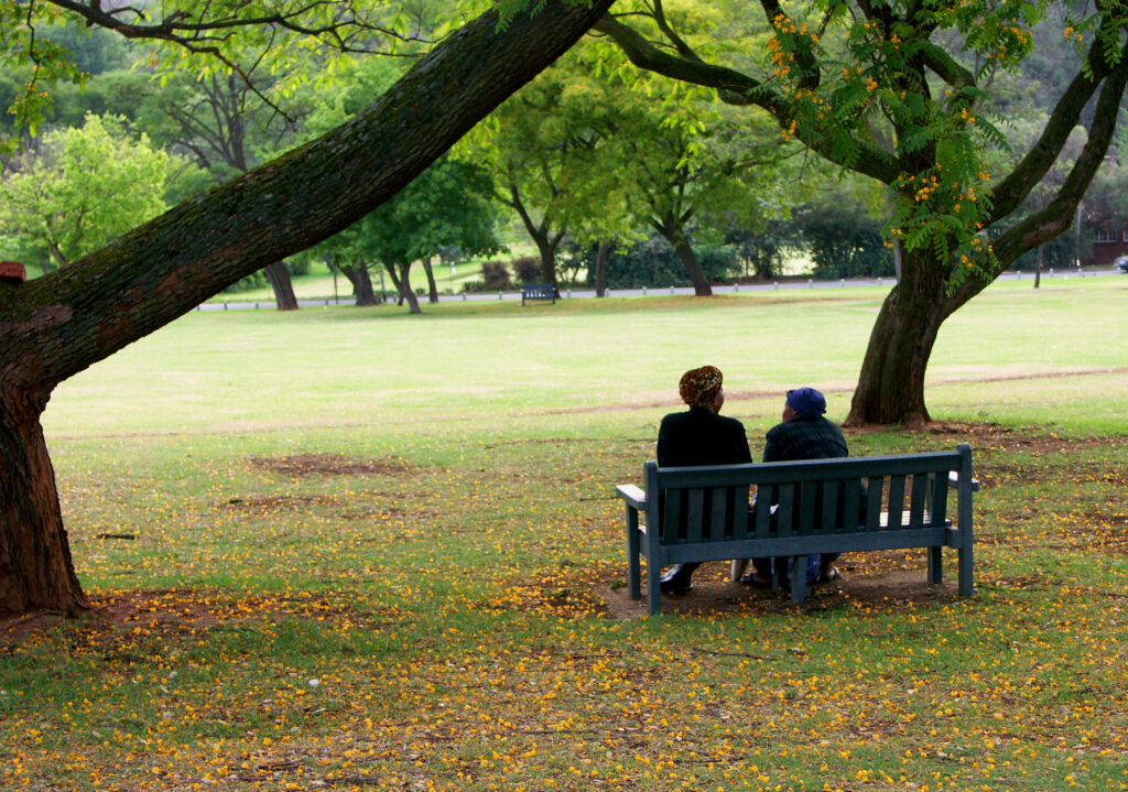 two women sitting in a park in johannesburg